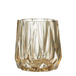 Amine Pale Amber Cut Glass Votive   Lovely pale amber coloured votive made of glass.  When the candle is lit in this votive, the flame reflects beautifully into the glass through the many facets.  Dimensions:  H9cm x Dia 7.5cm
