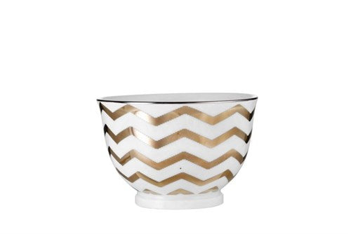 Adrienne Porcelain serving Bowl white & gold   Exclusive porcelain bowl designed with hand applied zigzag stripes in gold.  This bowl measures H6.5xØ10 cm and can hold 25 cl. Impress with not just your cooking skills and serve the delicious dish in this Adrienne bowl or incorporate it as a decorative element in your interior design and create a contrast with the classic and well-known.   NOTE: This bowl is dishwasher safe.  