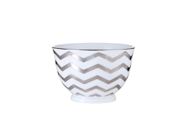 Adrienne Small Serving Bowl white & silver  Exclusive porcelain bowl designed with hand-applied zigzag stripes in silver.  This bowl measures H6.5xØ10 cm and can hold 25 cl. Impress with not just your cooking skills and serve the delicious dish in this Adrienne bowl or incorporate it as a decorative element in your interior design and create a contrast with the classic and well-known.  NOTE: This bowl is dishwasher safe.  
